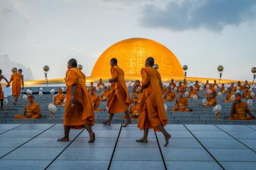 Monks walk up the side of Wat Phra Dhammakaya Temple before meditating as a part of the Earth Day 2022 celebration ceremony. Photographer: Matt Hunt / Neato