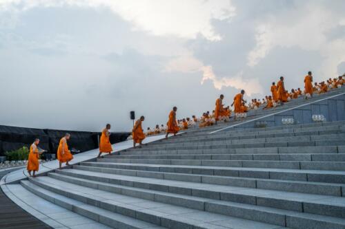 Monks walk up the side of Wat Phra Dhammakaya Temple before meditating as a part of the Earth Day 2022 celebration ceremony. Photographer: Matt Hunt / Neato