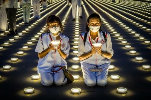 Devotees light LED lanterns and pray together as a part of the Earth Day 2022 celebration at Wat Phra Dhammakaya Temple. Photographer: Matt Hunt / Neato